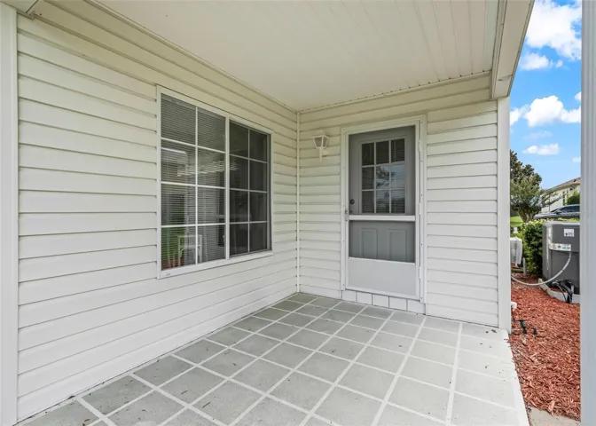 Convenient porch located just off the laundry room provides an additional outdoor space to enjoy the fresh air and beautiful surroundings.