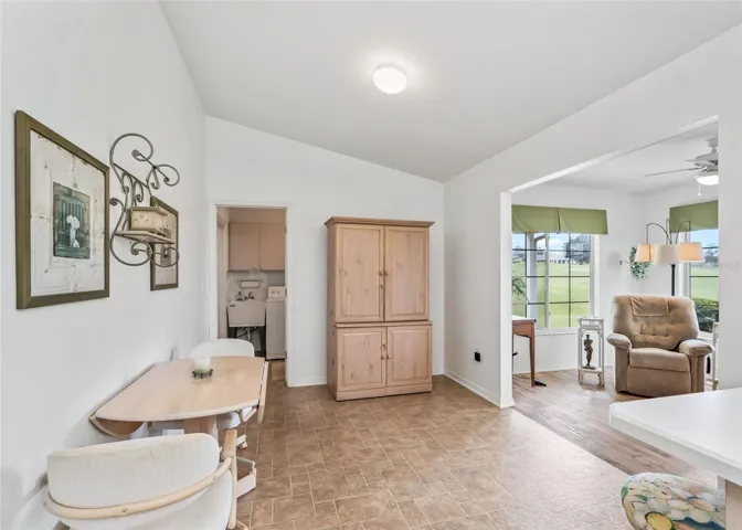 Bright and inviting kitchen that opens seamlessly to the additional living space, creating an open and connected layout. A convenient bar area provides comfortable seating at the counter, perfect for casual dining, entertaining, and everyday living.