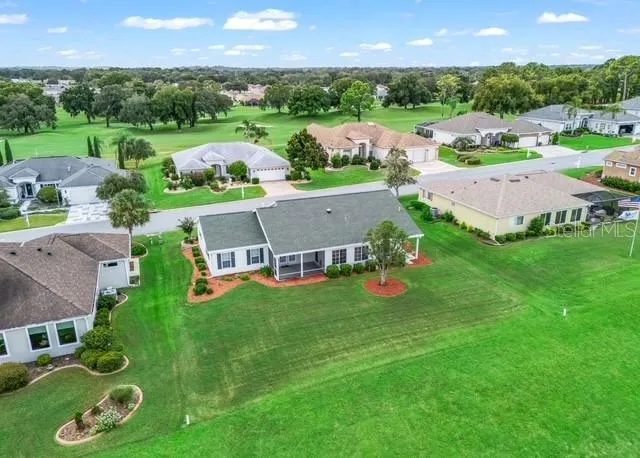 Aerial view showcases the home and surrounding neighborhood, highlighting the property’s attractive setting and the well-maintained community.