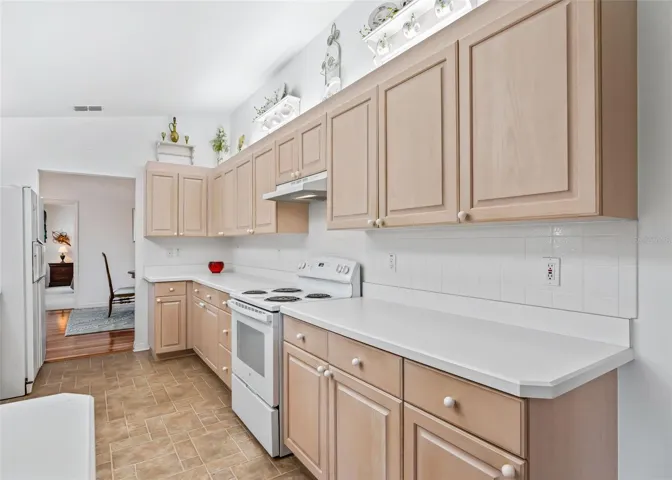 Bright and inviting kitchen featuring abundant cabinetry and generous counter space creating a bright and welcoming space for everyday living and entertaining.