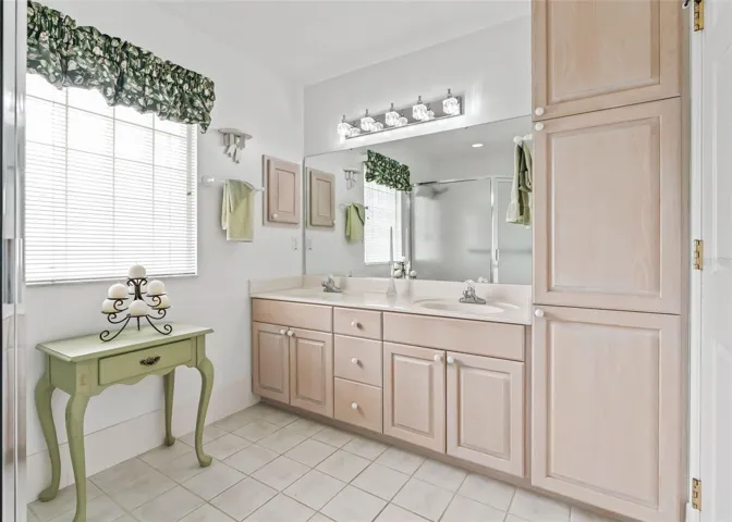Bright and inviting primary ensuite bathroom features a spacious double-sink vanity and lots of storage.