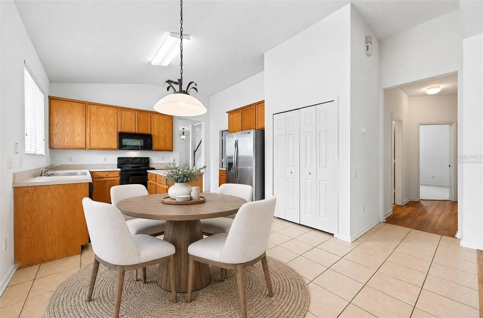 Casual dining off the kitchen, open to the family room. Virtually Staged.