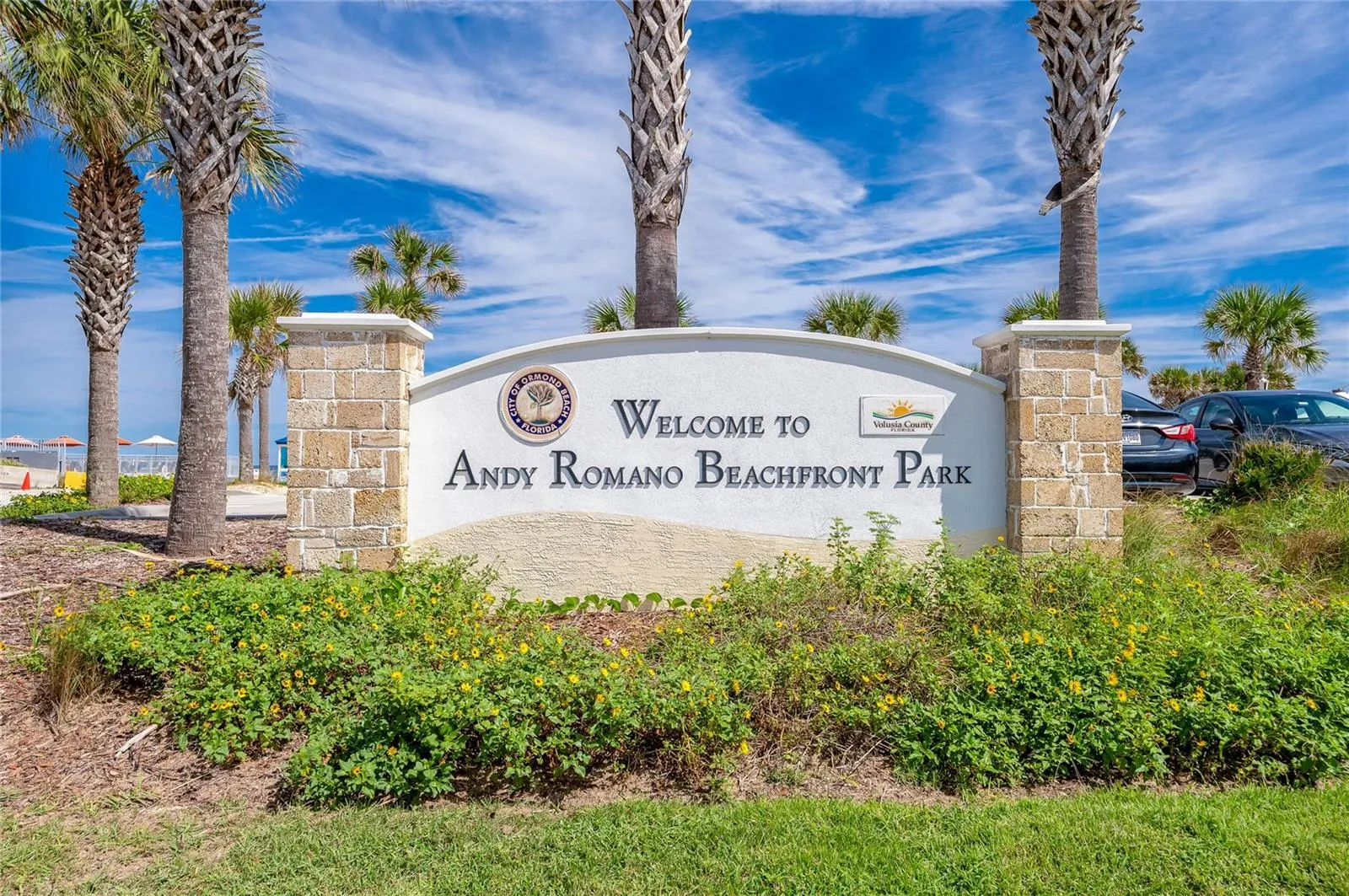 Welcoming signage identifies Andy Romano Beachfront Park, a nearby coastal recreation destination offering convenient access to the beach and Atlantic Ocean.