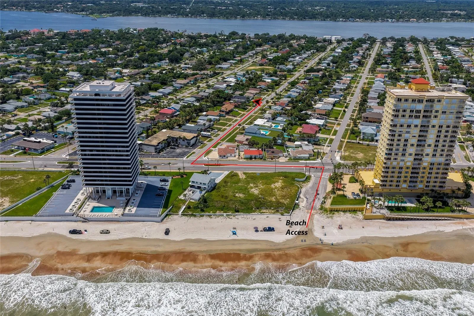 Direct ocean-facing aerial photo mapping the short, straight route from the property to the sandy beach and public beach access point.
