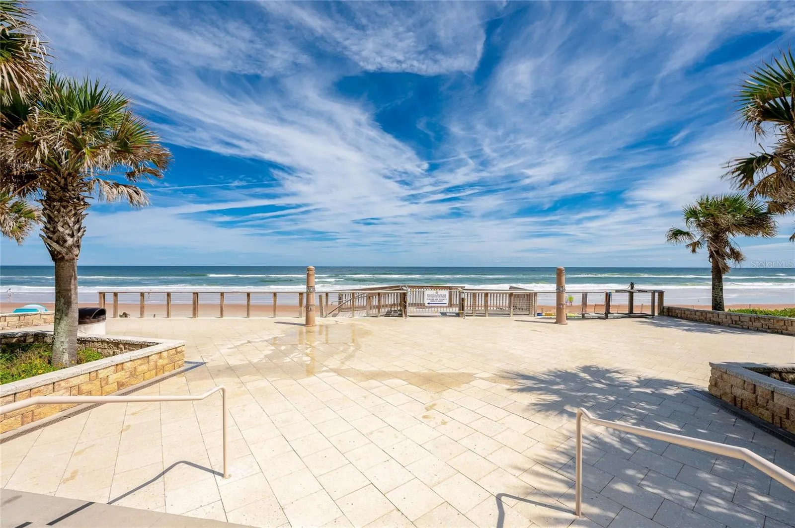 Expansive view from Andy Romano Beachfront Park showcases direct beach access and sweeping views of the Atlantic Ocean.