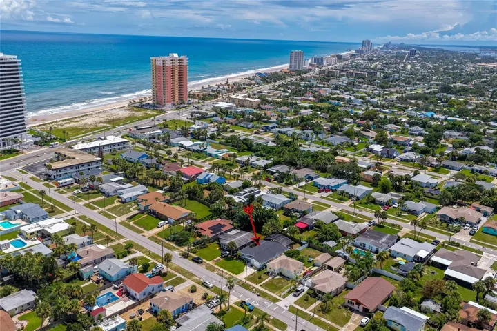 Expansive aerial view pointing out the property's location relative to the nearby oceanfront and coastal high-rises.