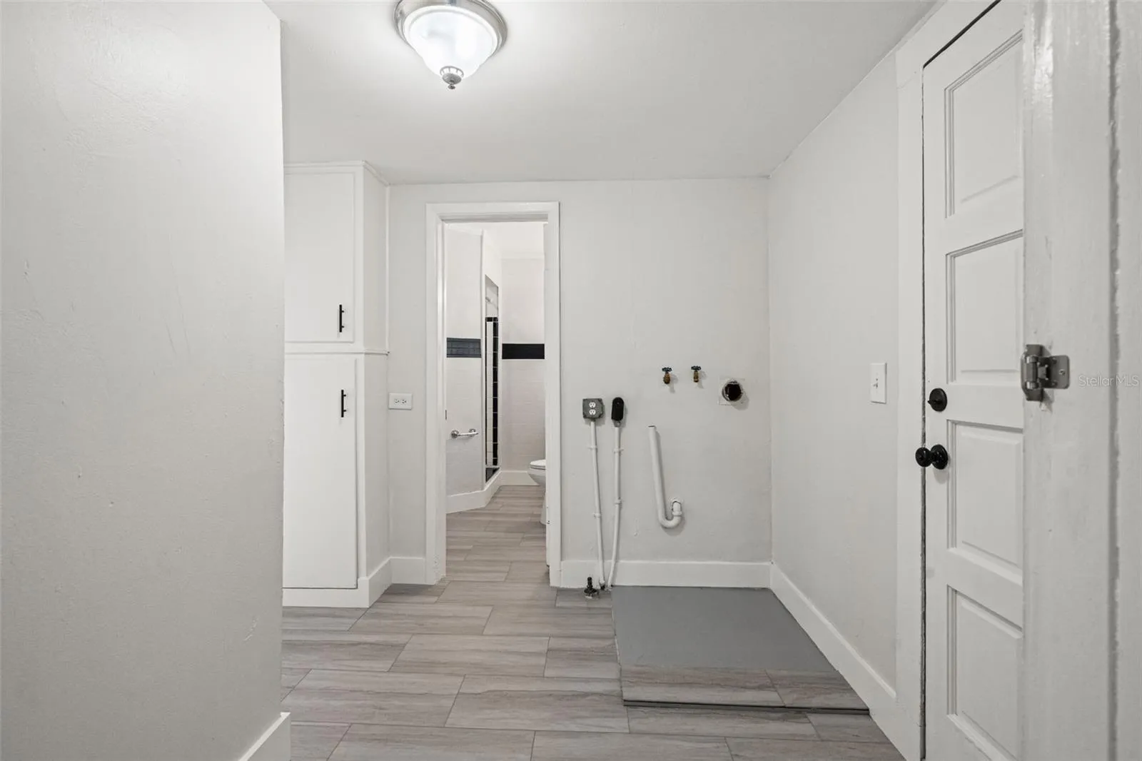 Laundry/mud room combo leading to back bathroom