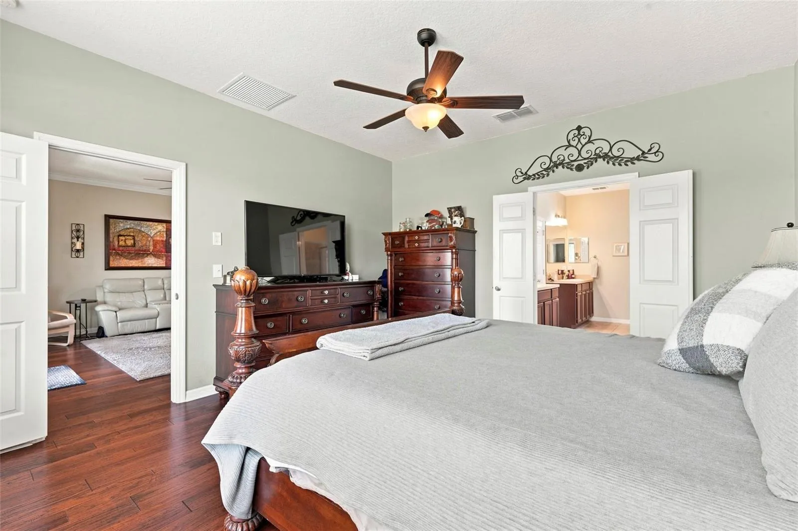 The primary bedroom features handscraped style engineered hardwood floor