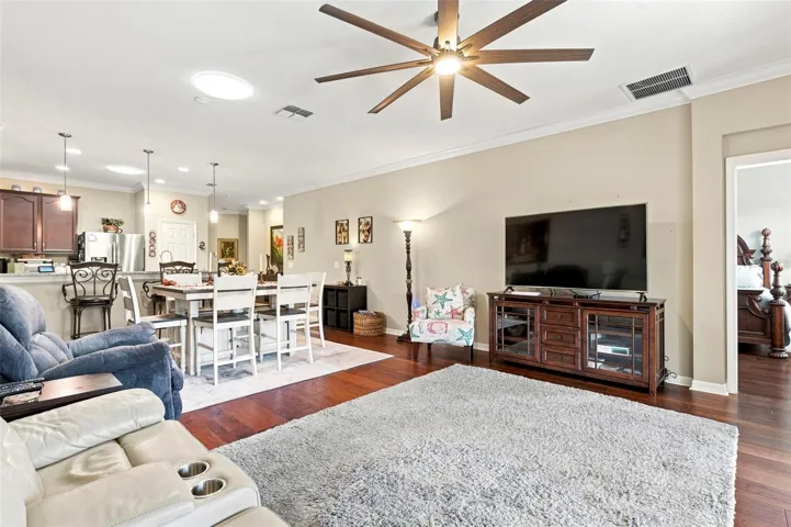 The living room features hand scraped engineered hardwood