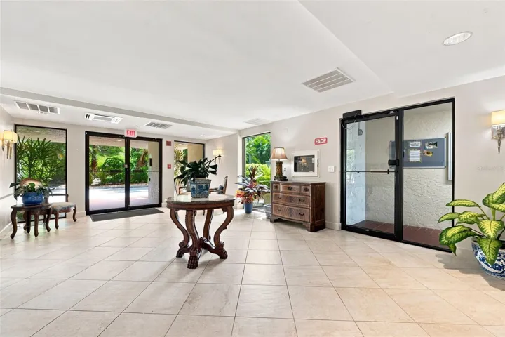 Lobby entrance from under building garage and front open parking