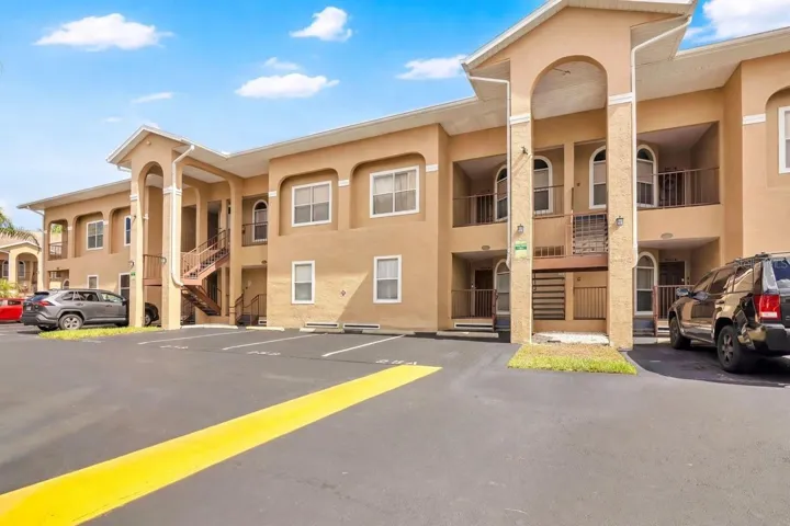 Welcome to Grand Palms, a well-maintained condo community with tropical landscaping and designated resident parking.