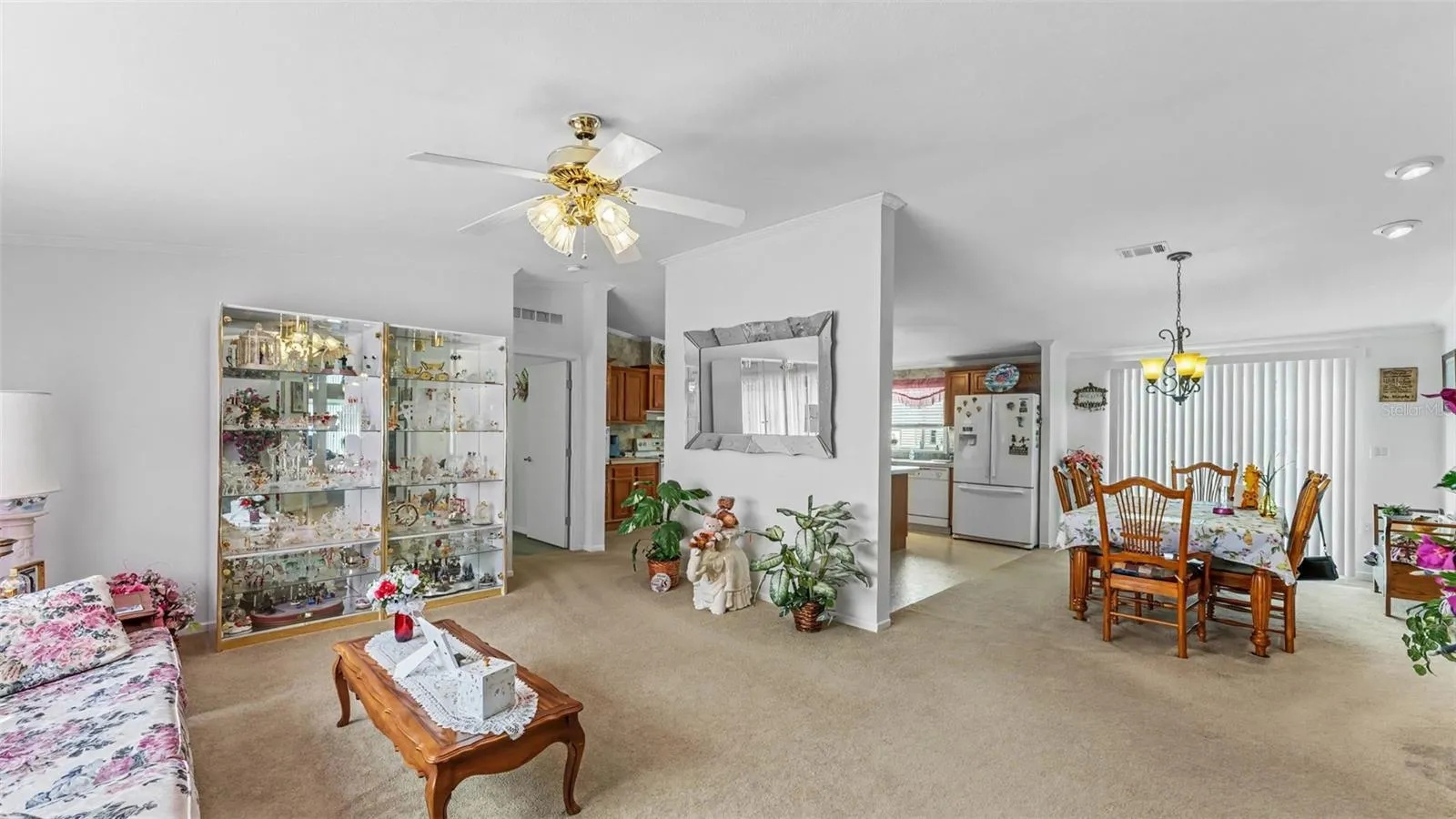 looking into family room from front door, dining room and kitchen behind wall