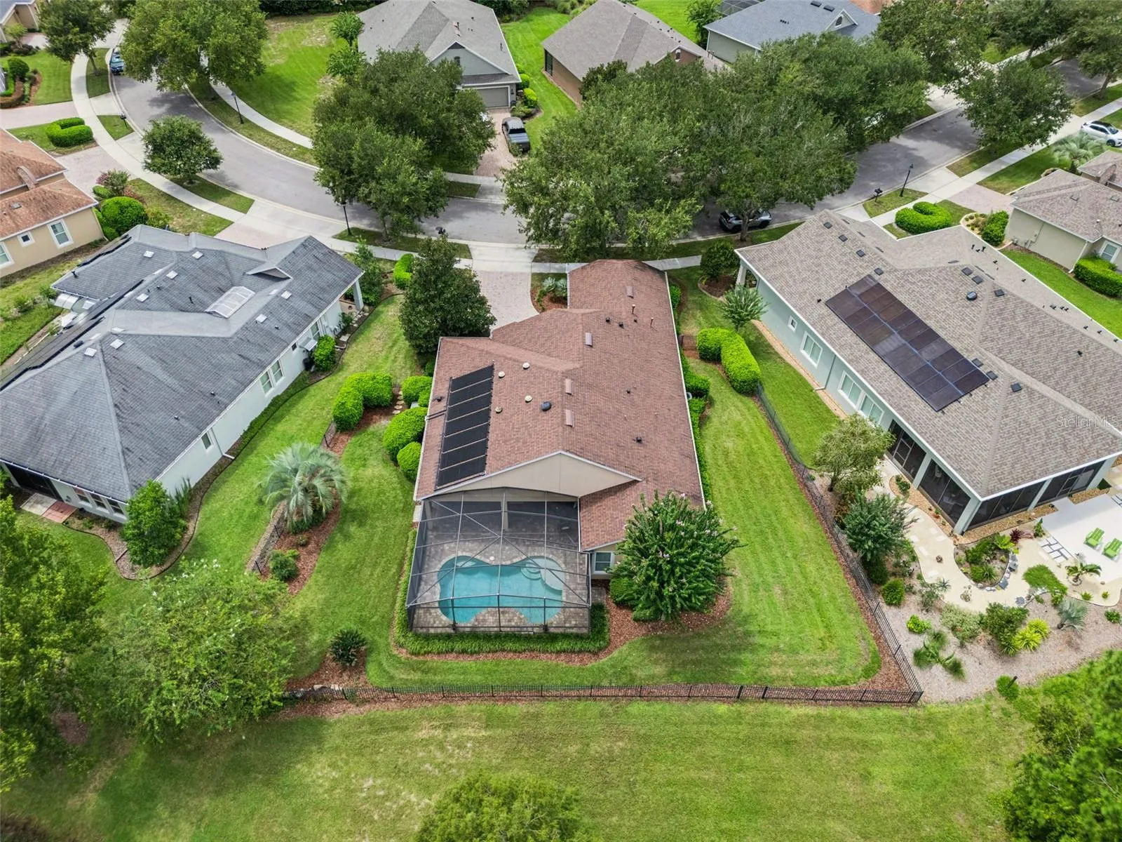 Aerial view of the home & aluminum rail fenced yard