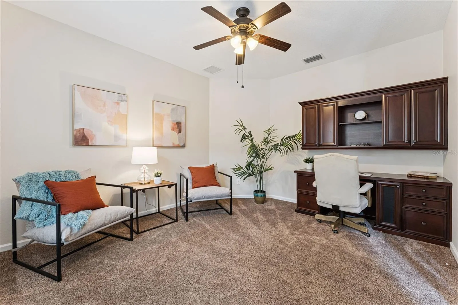 12' x 14' Den/office w/ built-in desk, ceiling fan & double door entry