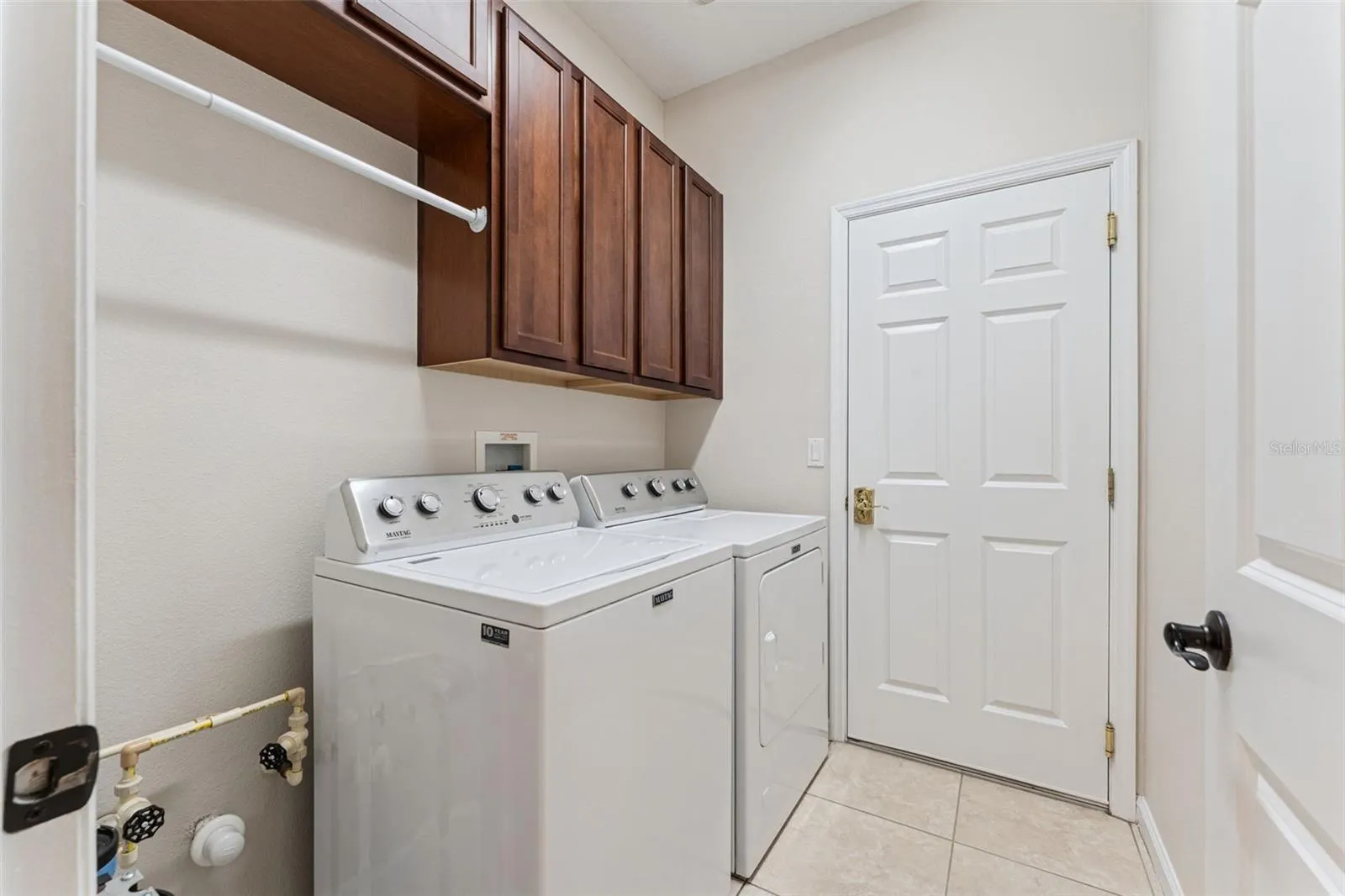 5'6" x 7' Utility Room w/ washer, natural gas dryer, storage cabinets & pre-plumbing for a future laundry tub