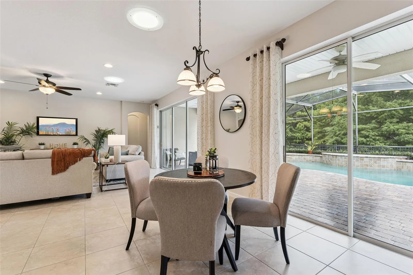View of the screen enclosed solar panel heated pool from the Dinette area