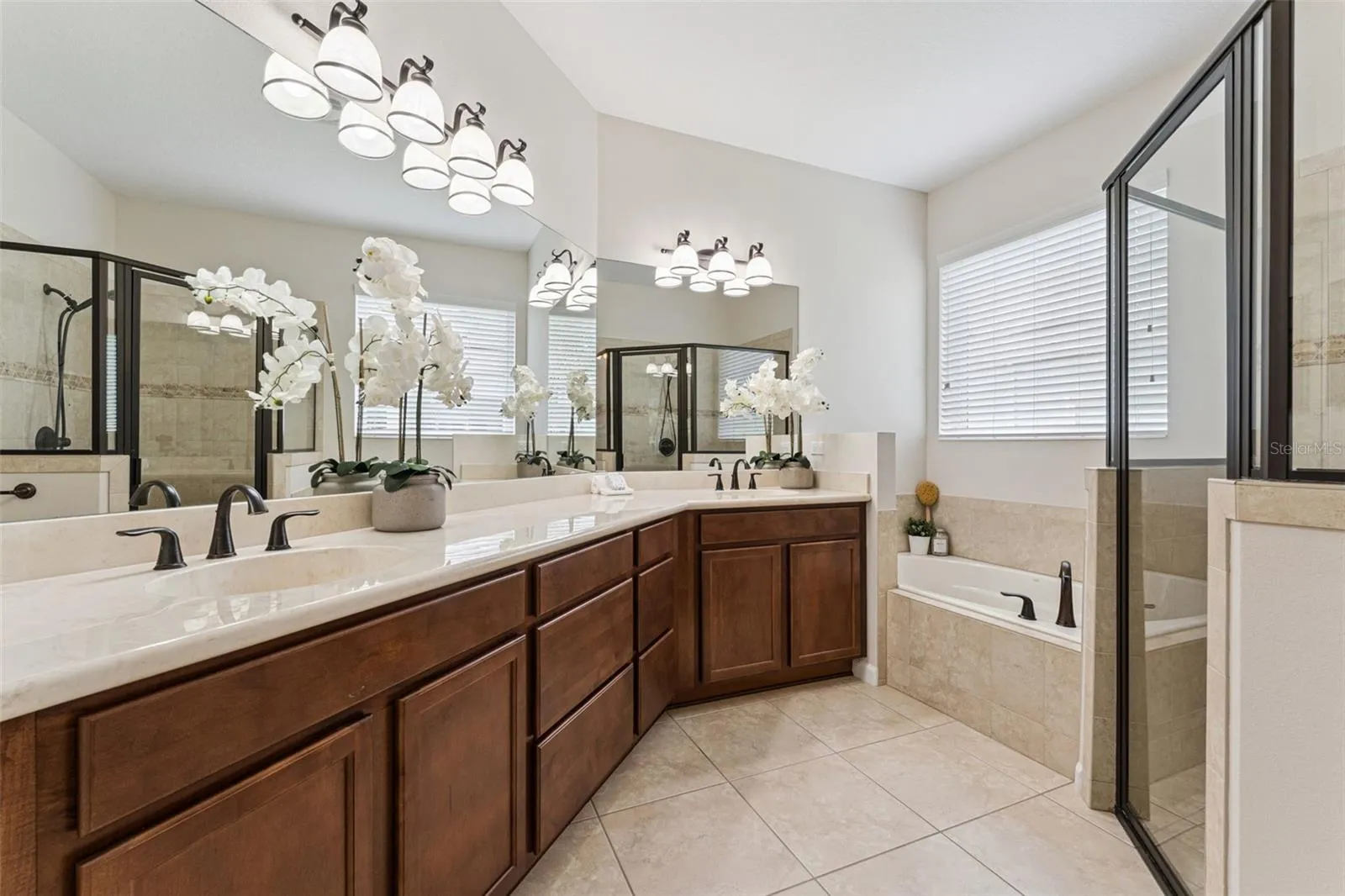 Primary Bathroom w/ dual sinks, corner soaking tub & a glass enclosed walk-in shower