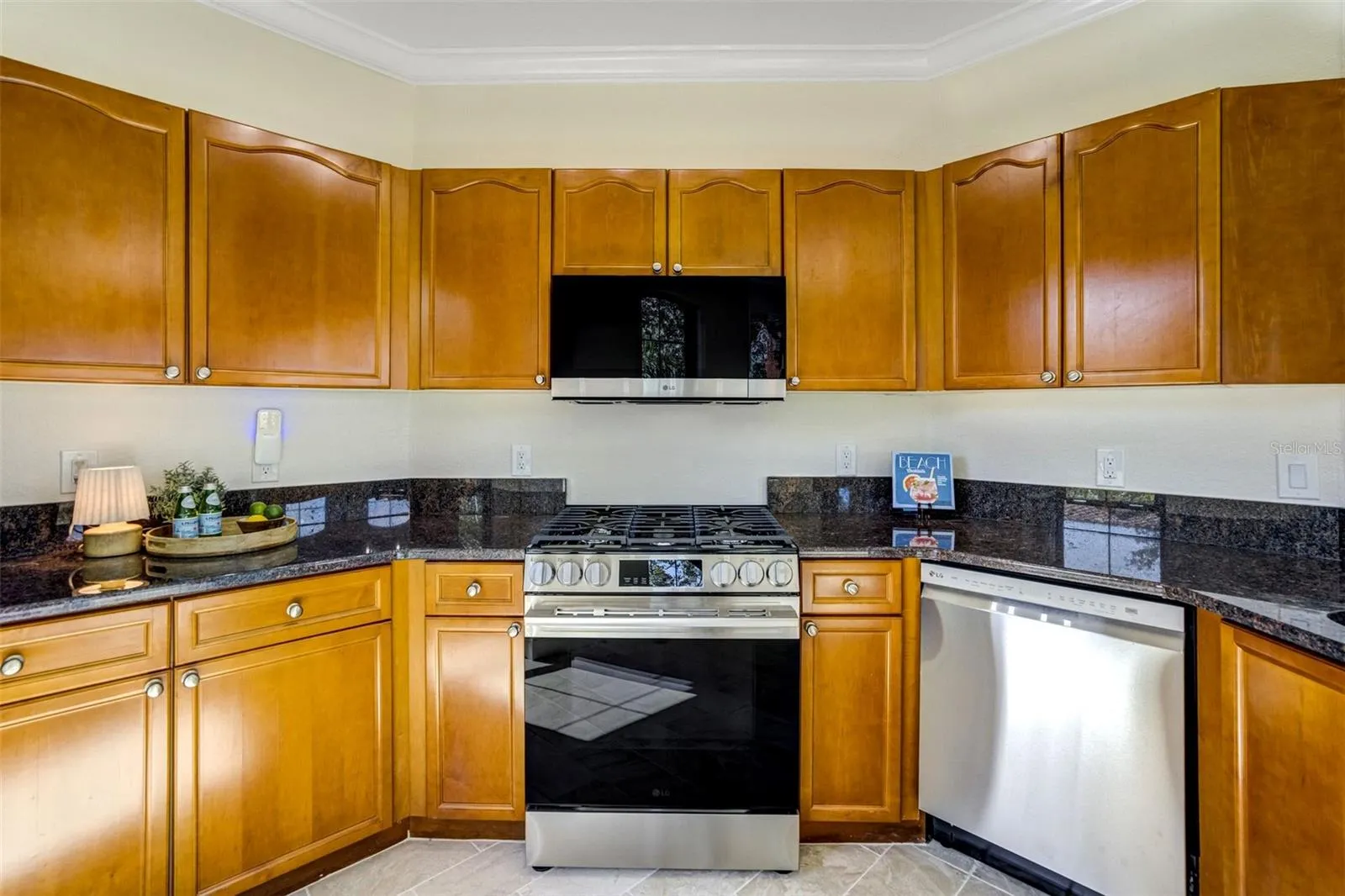 New stainless steel appliances with gas range and new marble flooring