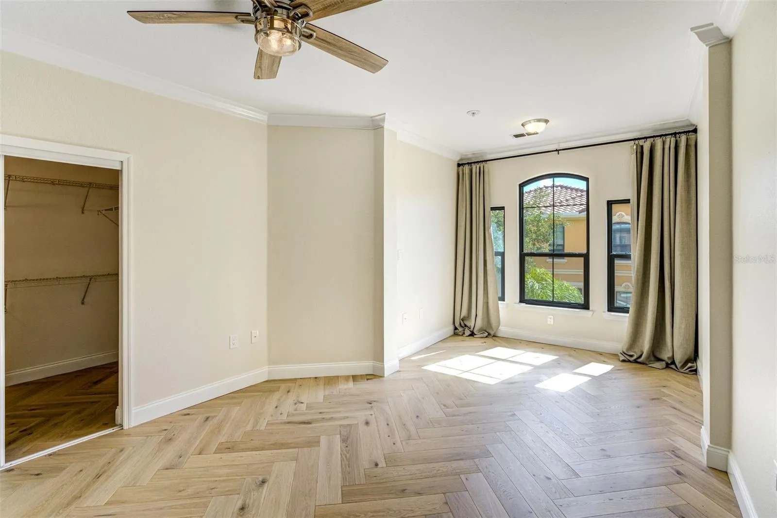 Primary bedroom with oversized walk in closet and new wood floors