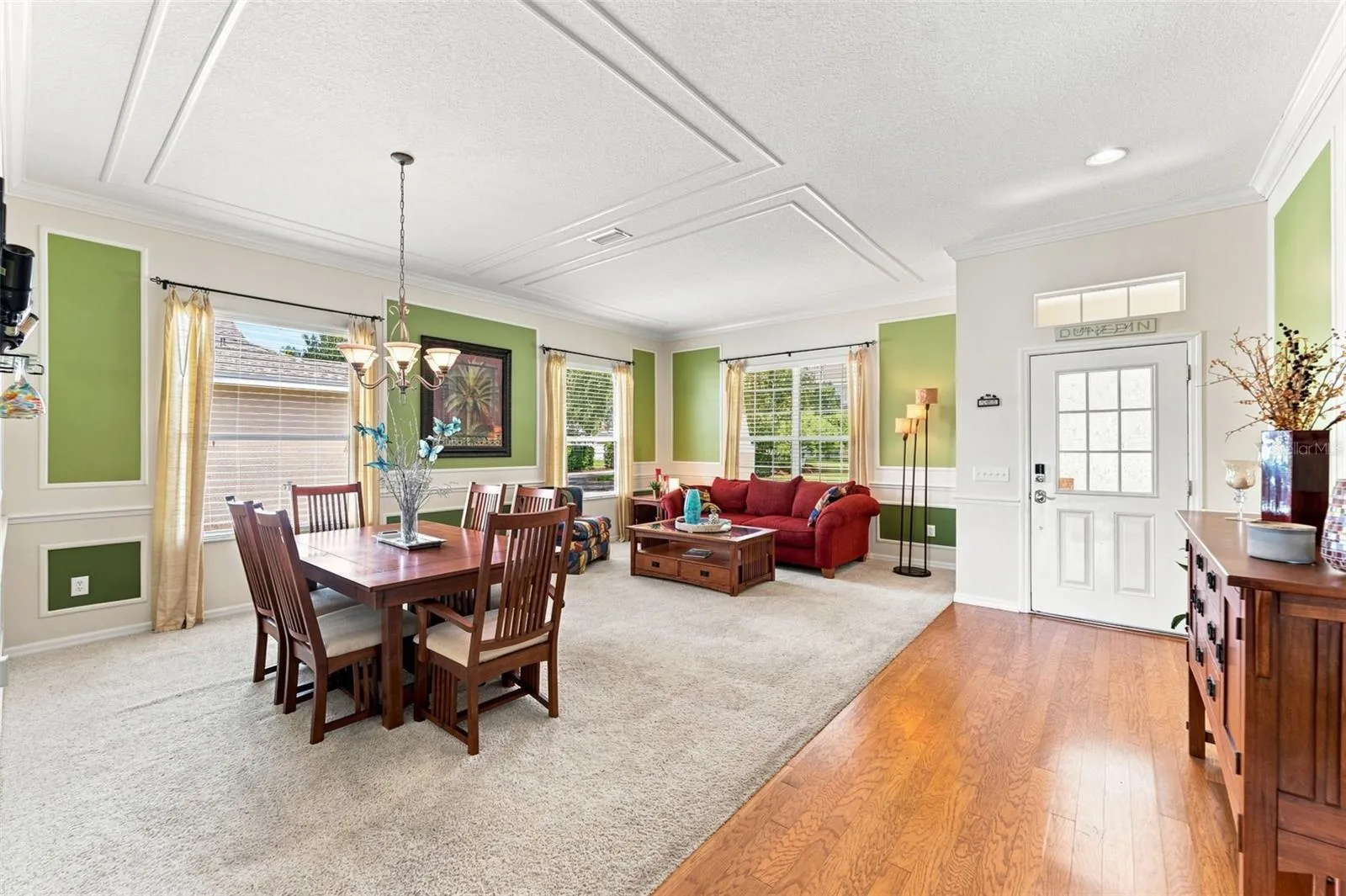 Welcome in-Notice the details such as the crown molding accents and warm wood flooring