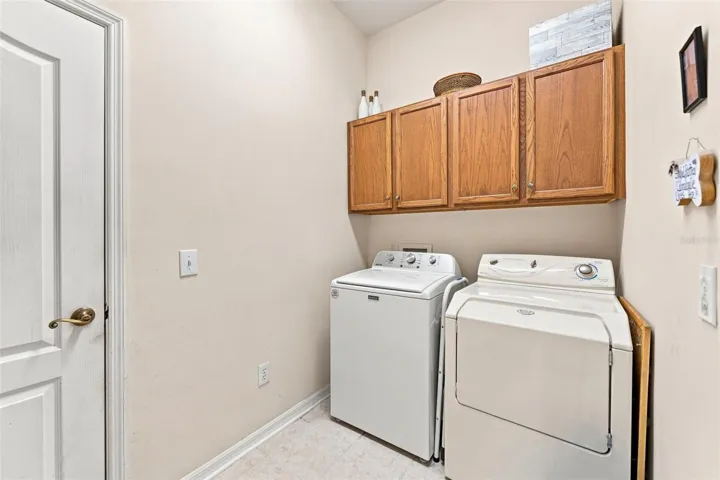 Inside Laundry Room with storage