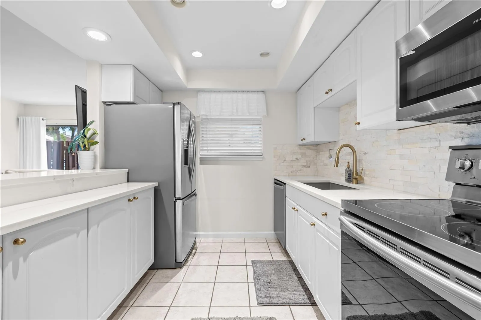 This stunning unit features a remodeled kitchen with stainless steel appliances, including dishwasher
