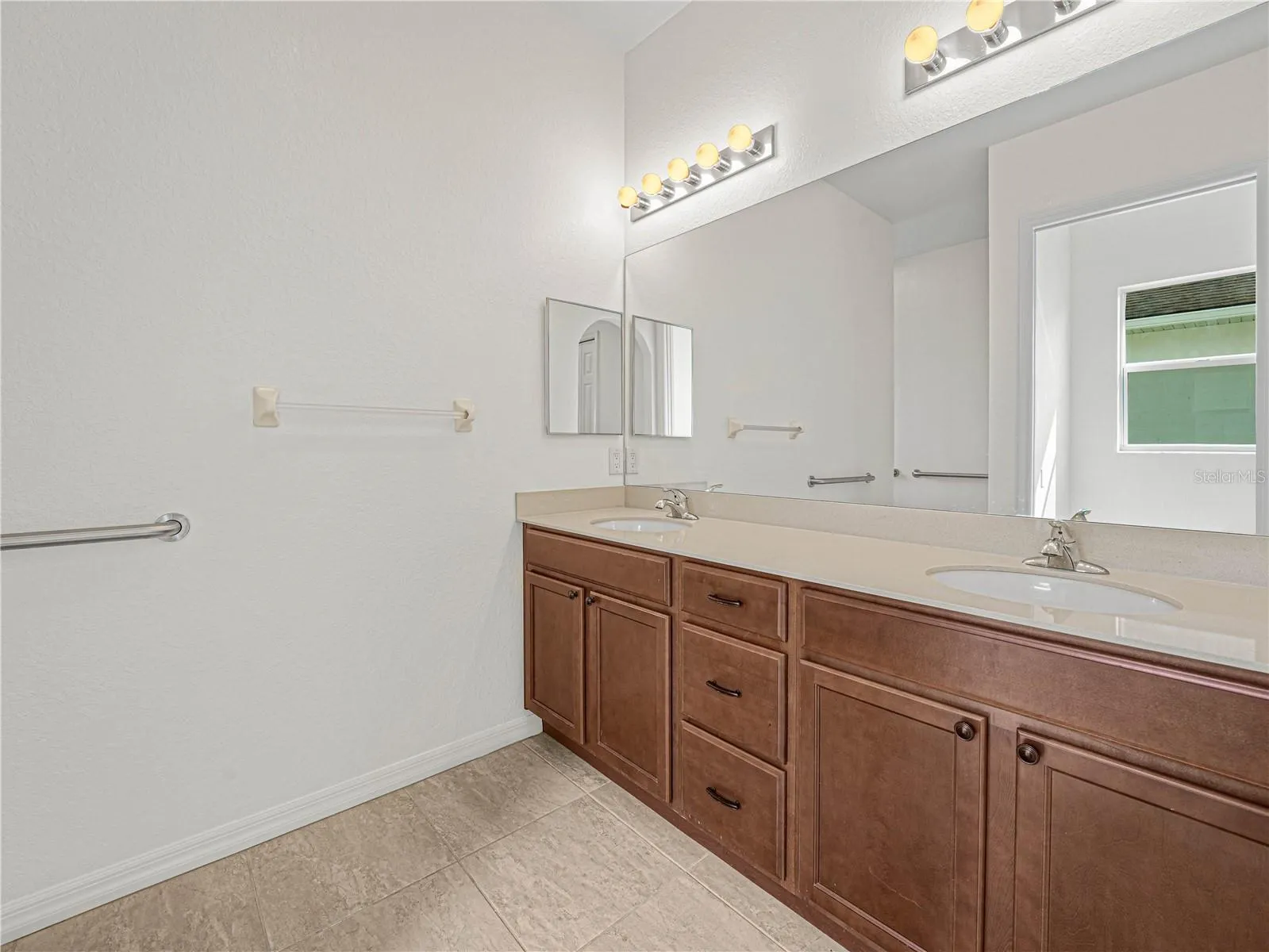 Double Sink Vanity in Primary Bath with Tile Flooring