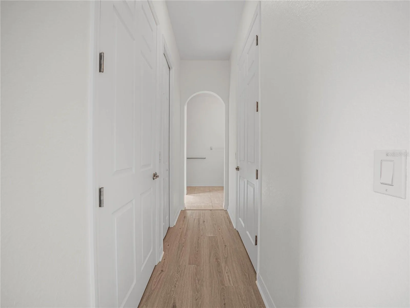 Hallway with Walk In Closets, Linen Closet to Primary Bath