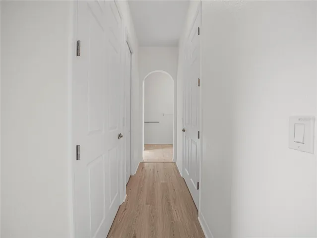Hallway with Walk In Closets, Linen Closet to Primary Bath