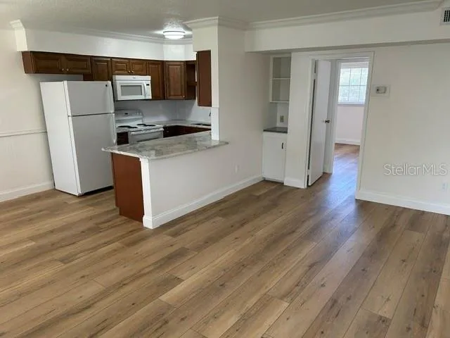 Living Room looking into Kitchen with Breakfast Bar and room for stools