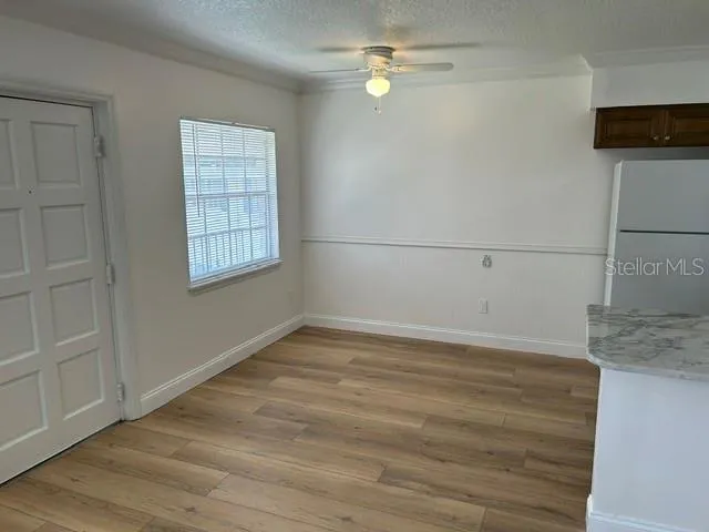 Dining Room with Ceiling Fan, Chair Rail, and beadboard wainscotting