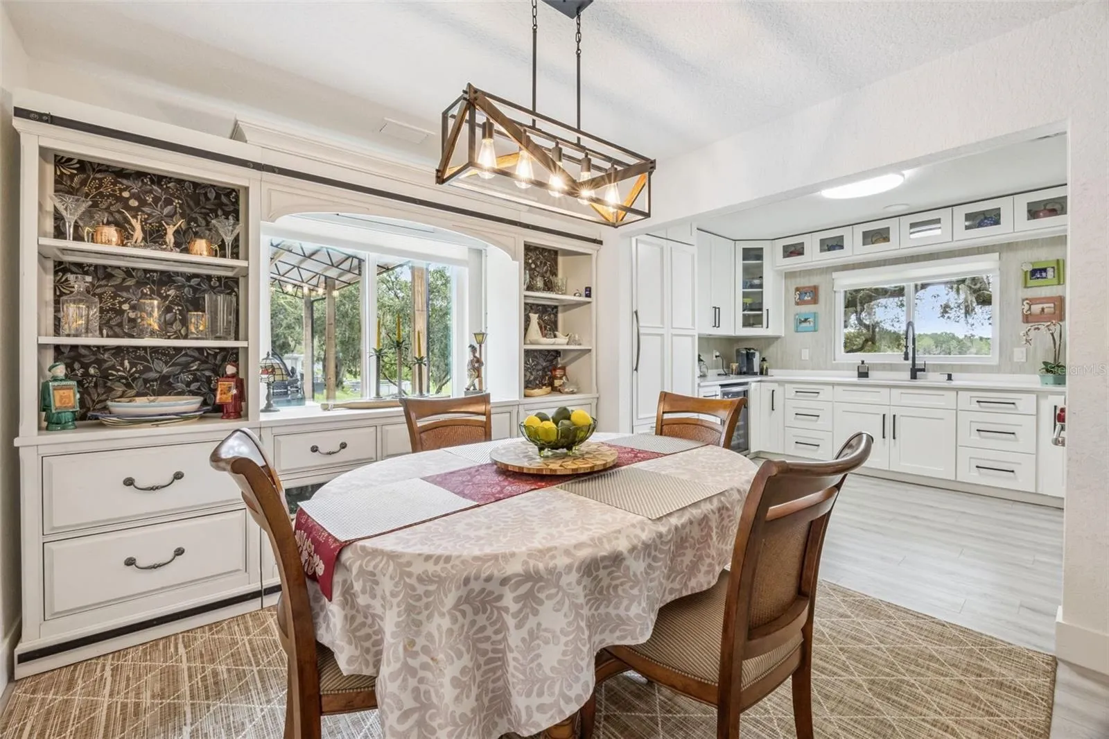 Elegant dining area featuring a built-in china hutch, flowing seamlessly into the updated kitchen.