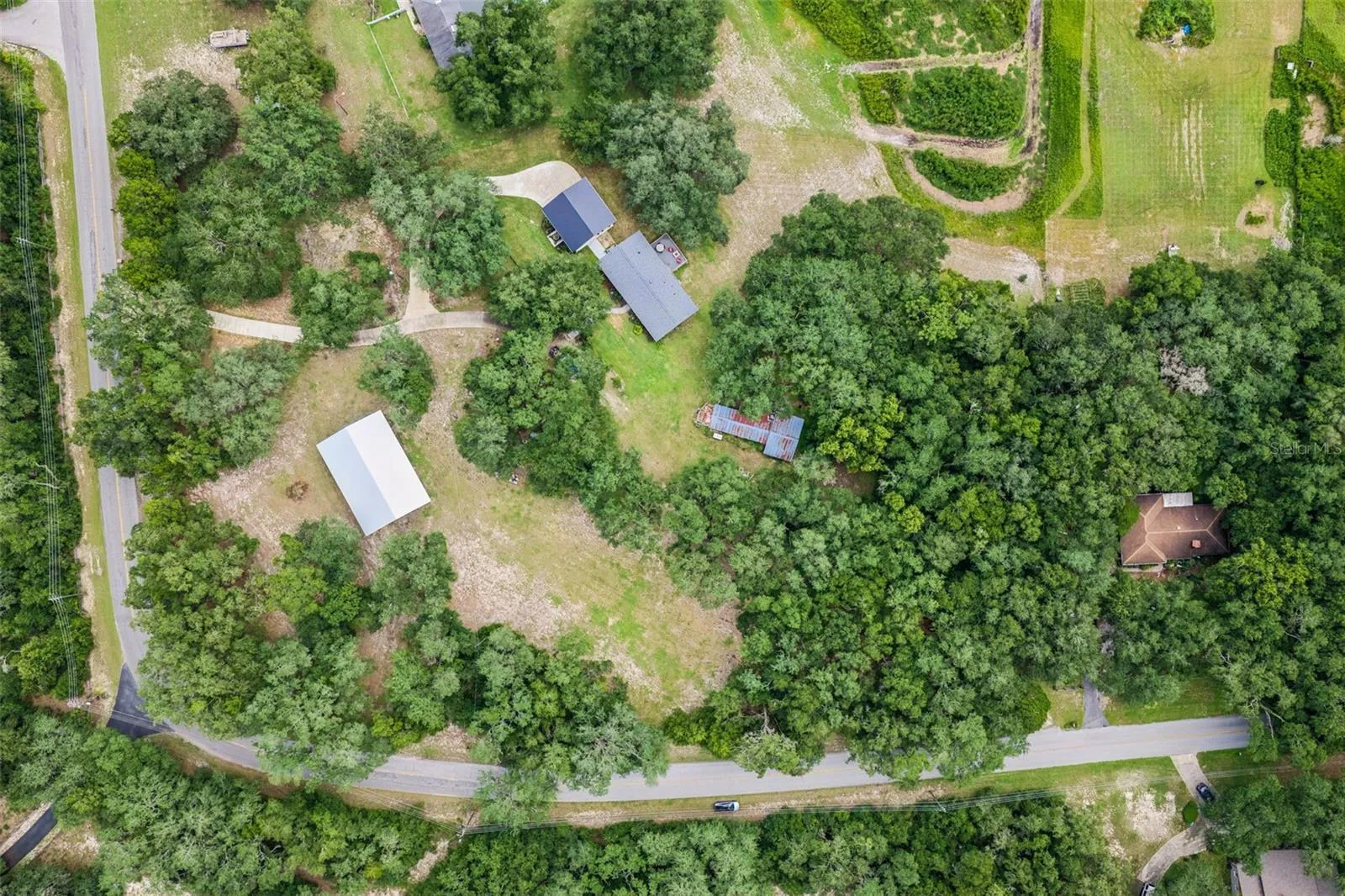Aerial view of the property showcasing the surrounding landscape and natural canopy.