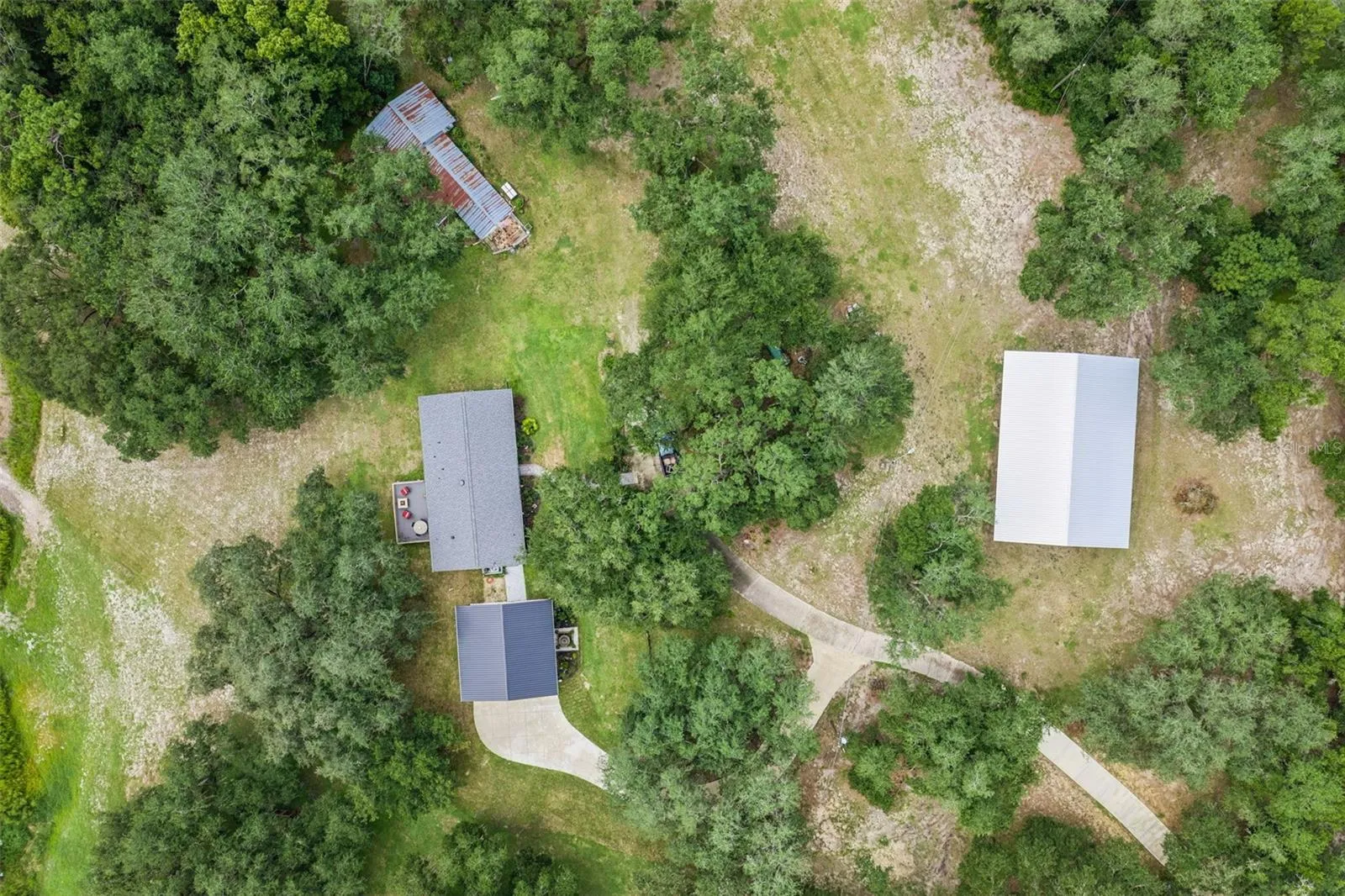 Final aerial perspective showing the surrounding rolling hills, open pastures, and the peaceful Lake County setting.