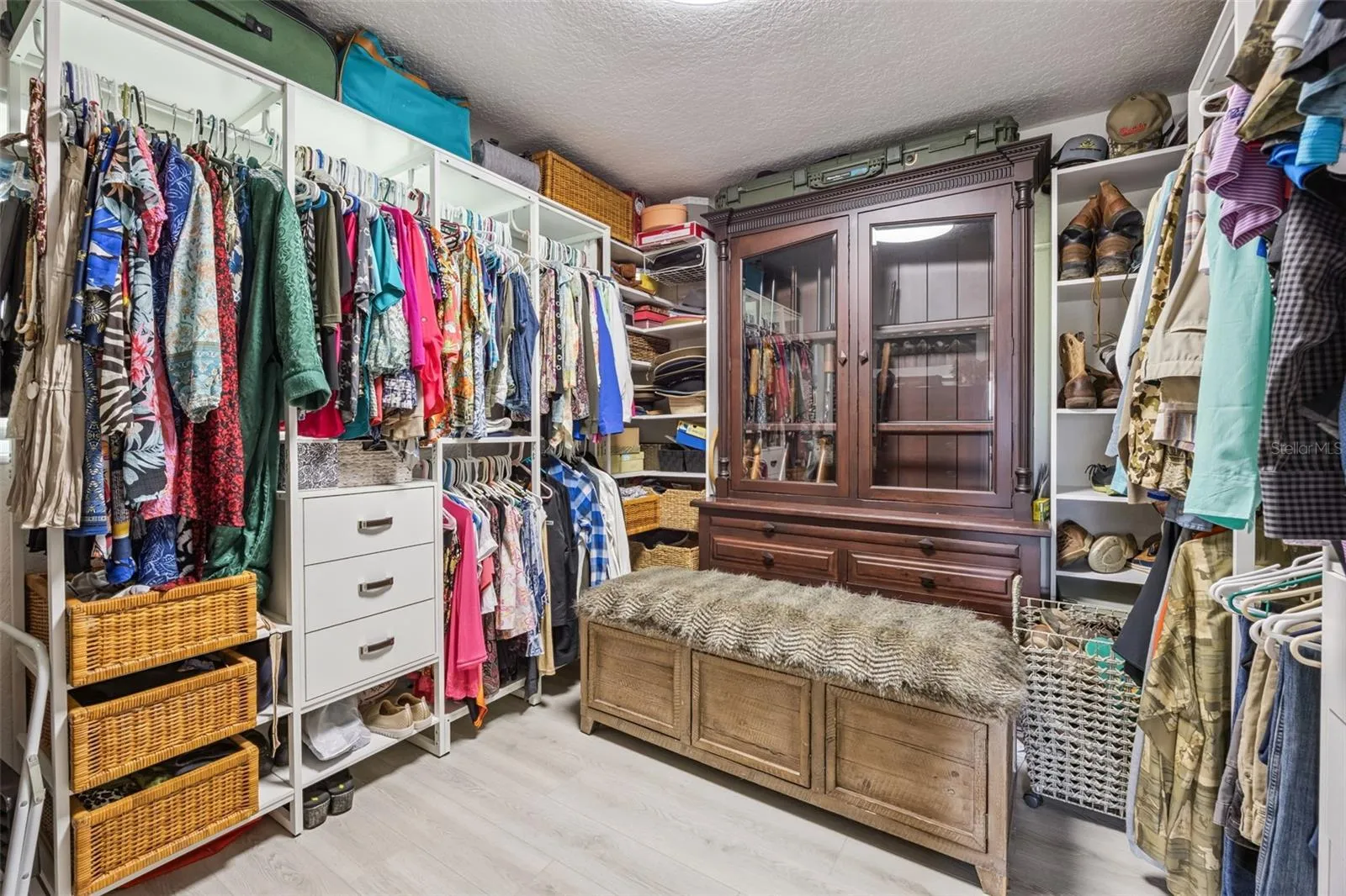 Expansive walk-in closet with built-in organizers, shelving, and room for an entire wardrobe.
