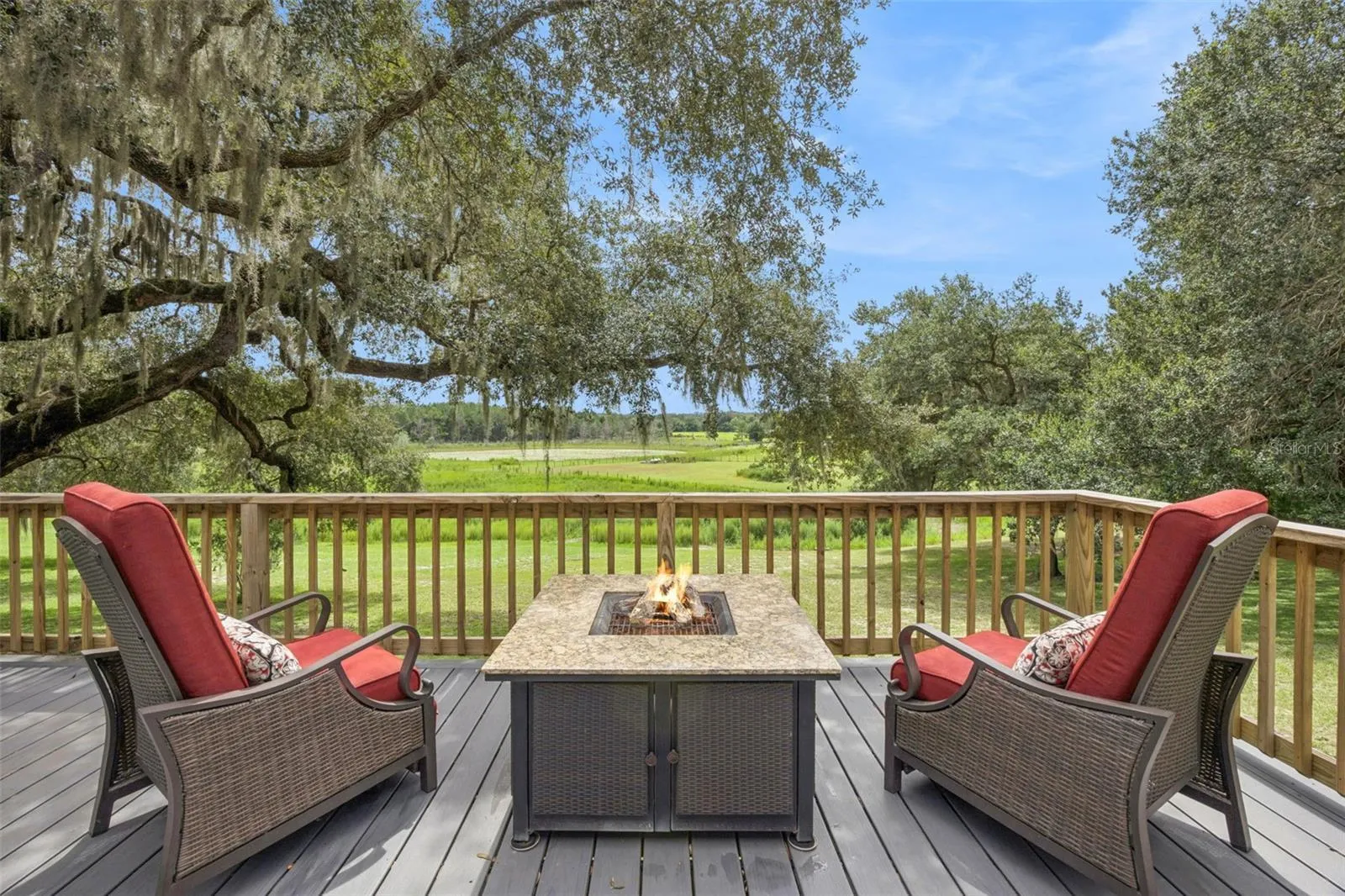 Imagine evenings around the fire pit on the elevated deck, soaking in panoramic views of green pastures framed by moss-draped oaks.