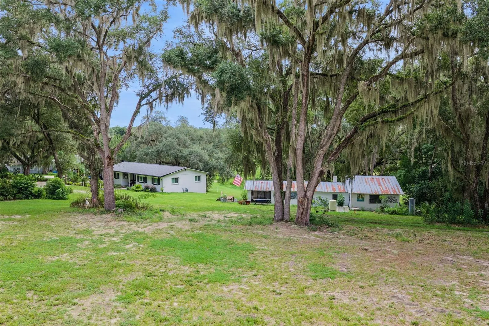 From above, the full picture unfolds: a private homestead with pastoral views in every direction.