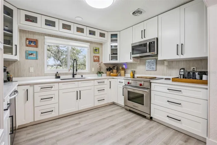 Chef-inspired kitchen with a professional-grade range, quartz countertops, and crisp white shaker cabinetry.