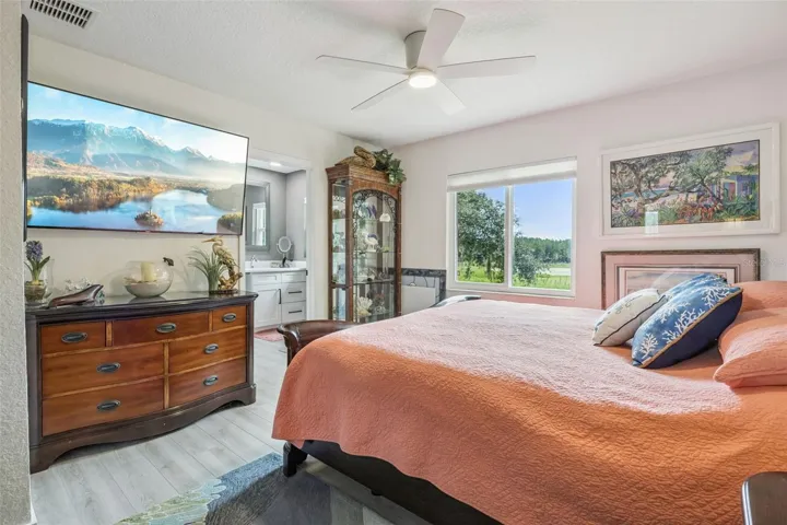 Generously sized primary bedroom with direct en-suite bath access and sweeping pastoral views that stretch for miles.