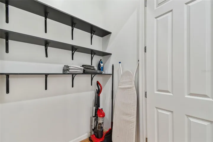 hall closet leading to primary bedroom