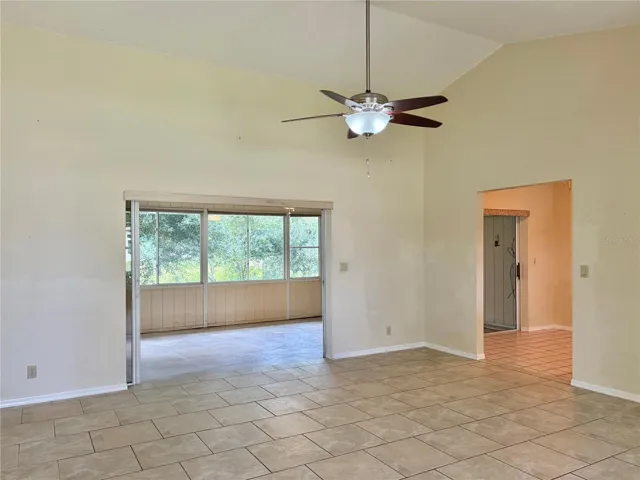 LR has a Ceiling Fan on a Vaulted Ceiling