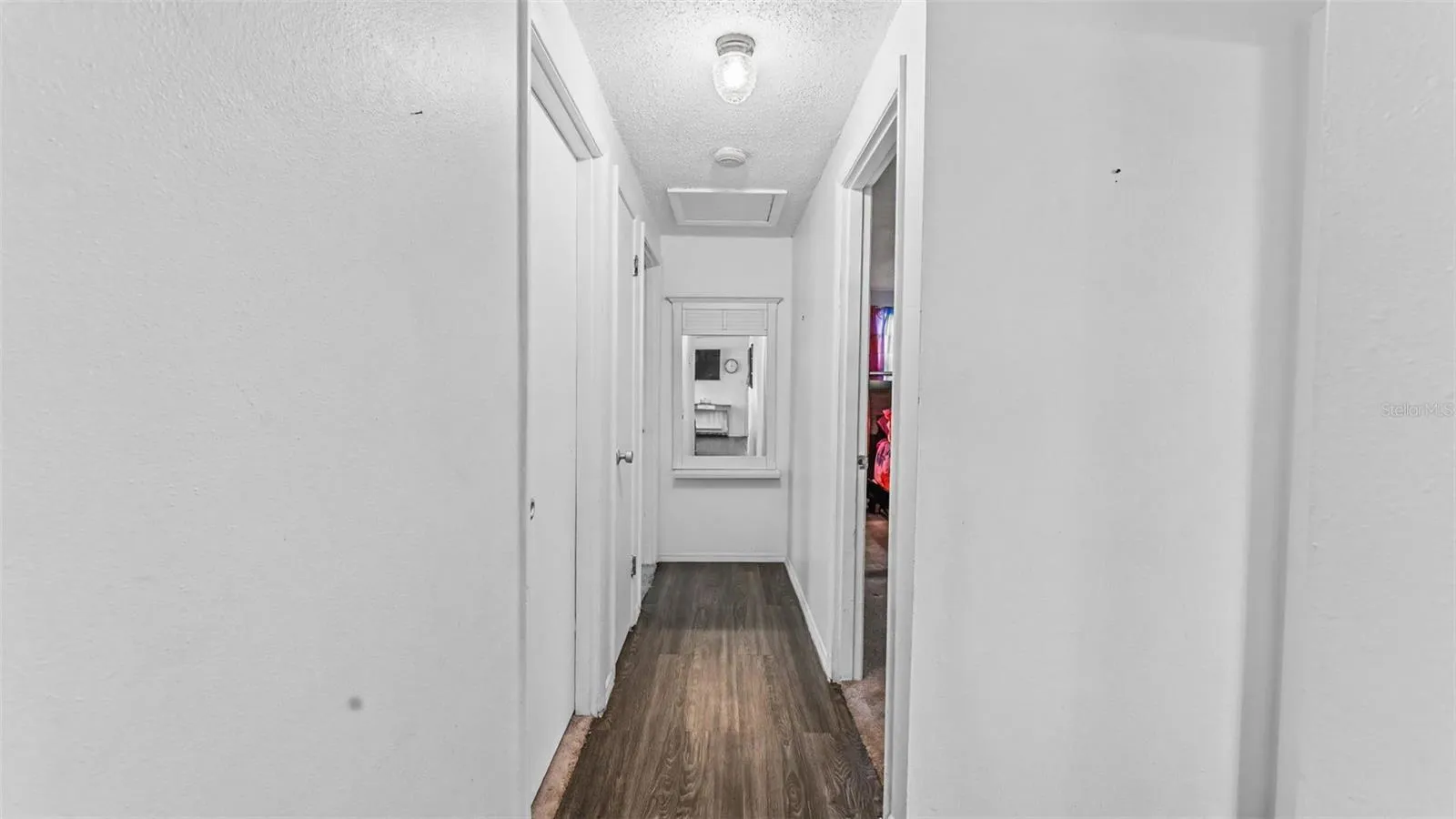 Hallway to bedrooms and primary bathroom