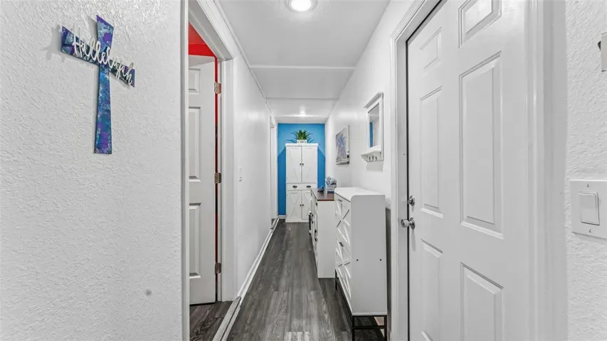 Hallway to laundry, 2nd bathroom and carport to the right
