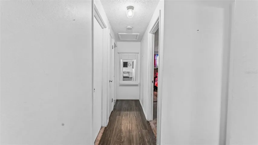 Hallway to bedrooms and primary bathroom
