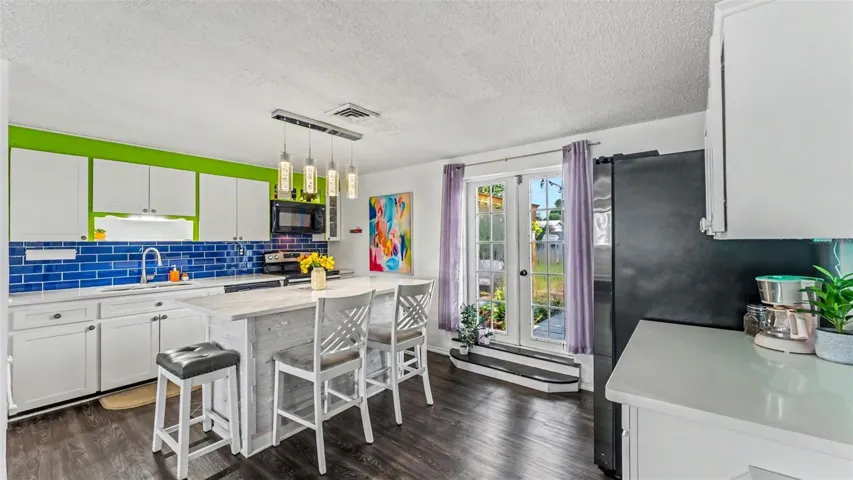 Kitchen from laundry hallway. French doors to back yard