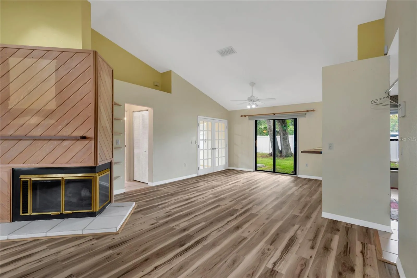 Light and Airy Dining Area with pass-through bar to Kitchen and open to Living Room with Sliding Doors out to backyard.