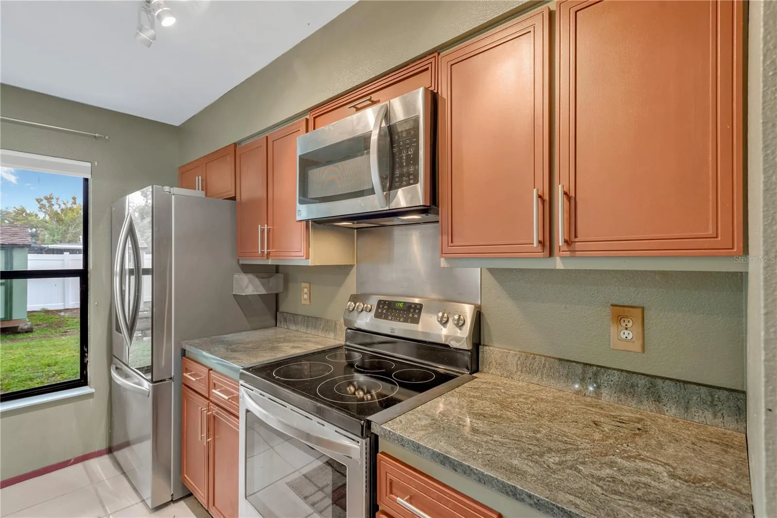Kitchen with Stainless Steel Appliances, Ceramic Tile flooring and Granite countertops