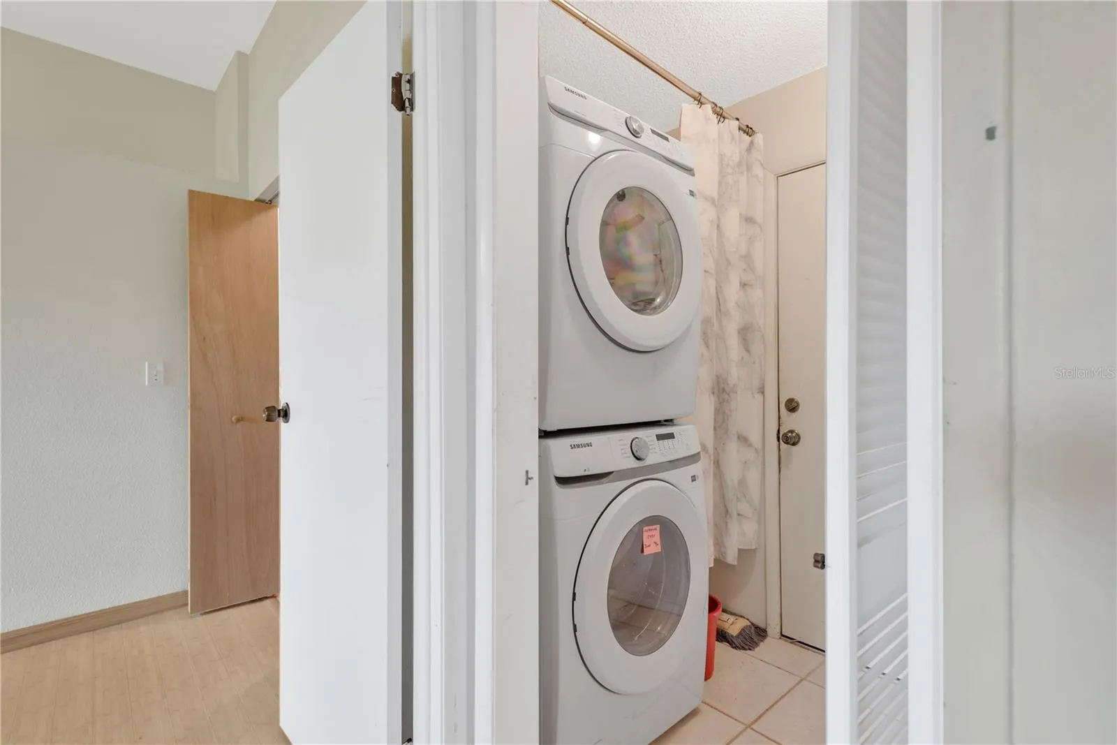 Inside Laundry/Mud Room with door into 2 Car Garage.