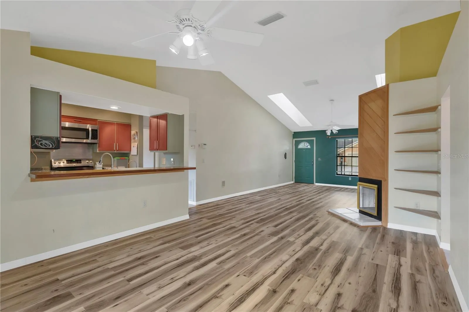 Dining Area with ceiling fan, looking at pass-through with bar into kitchen - convenient and great for entertaining