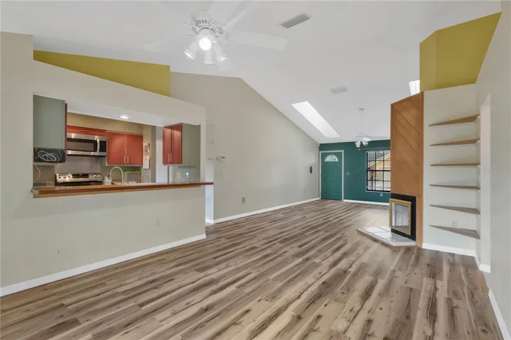 Dining Area with ceiling fan, looking at pass-through with bar into kitchen - convenient and great for entertaining